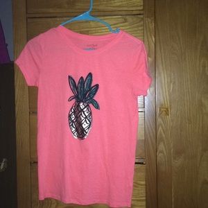 Pink T-shirt with a gold pineapple on it